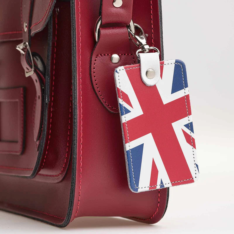 A leather bag charm featuring the Union Jack, clipped on a handbag