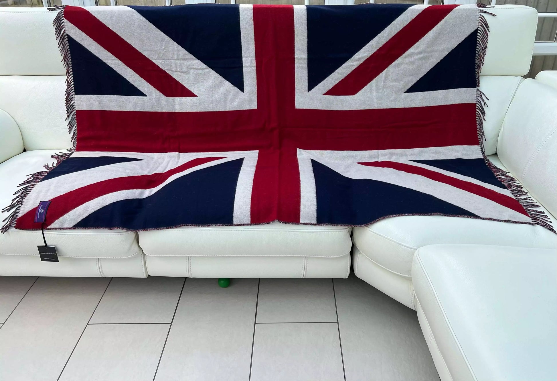 An open Merino wool throw featuring the Union Jack in a living room.