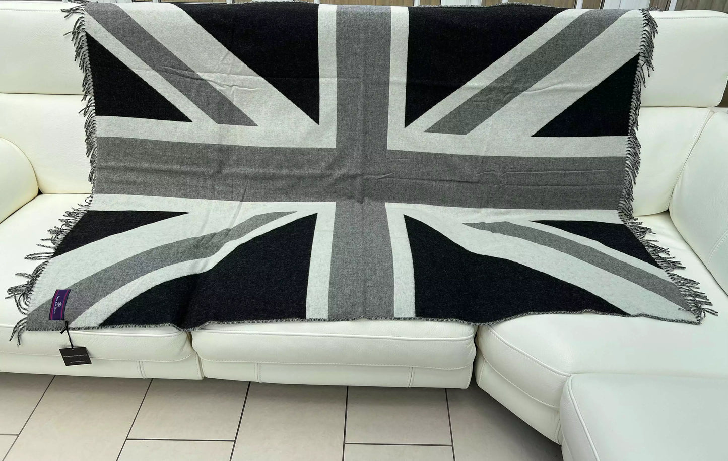 An open throw featuring the Union Jack, in black and white,  in a living room.